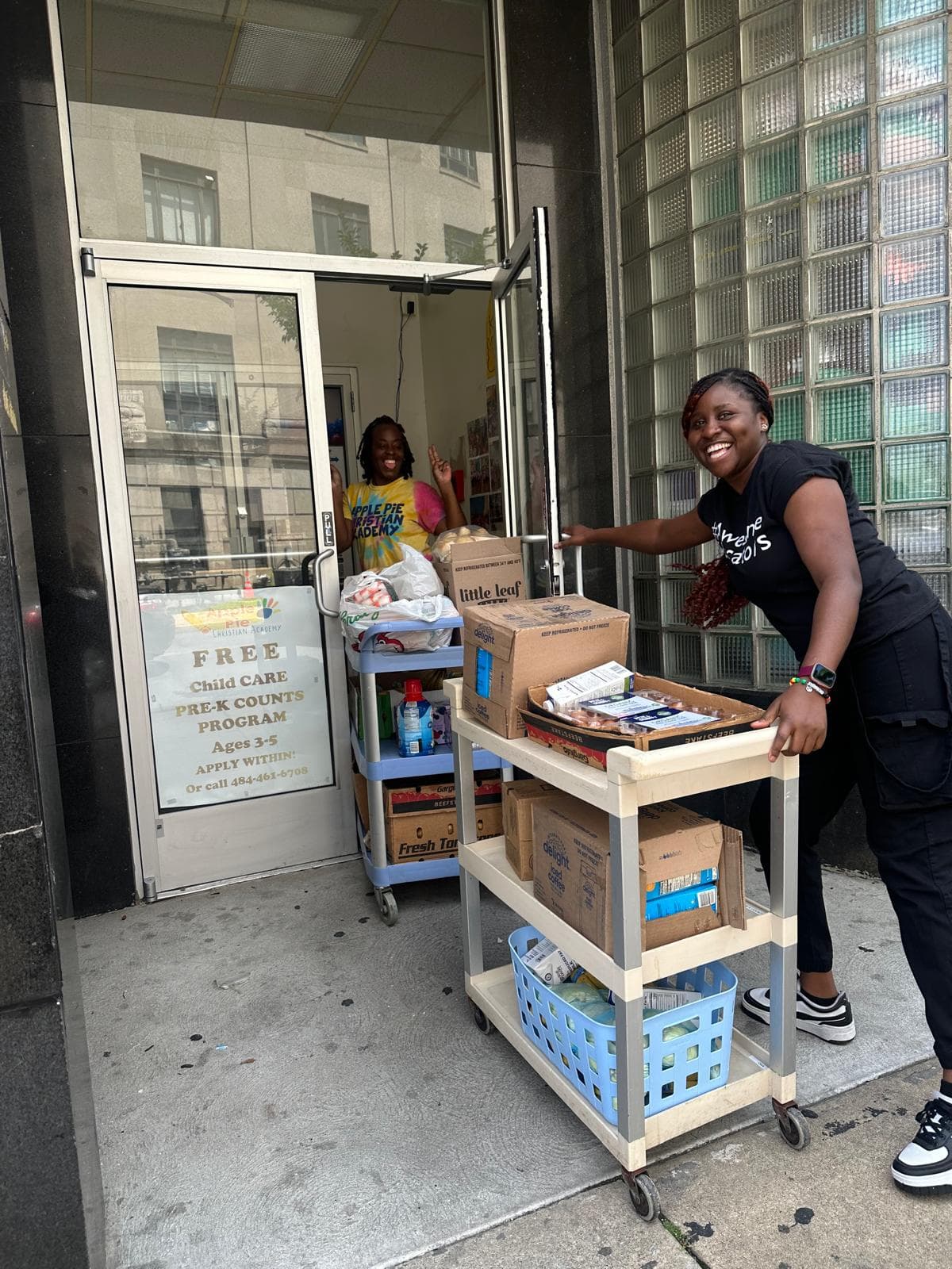 Community members gathered around donated pantry supplies