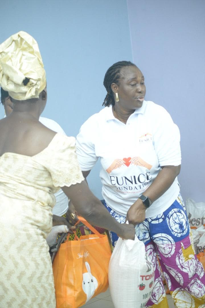 Secretary Carol Olloh at a food donation distribution